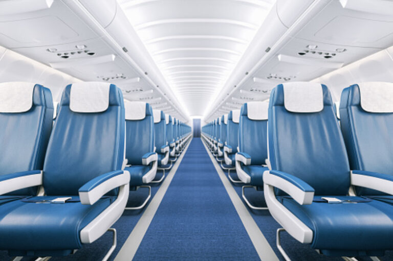 Interior of a commercial airplane cabin with blue leather seats.